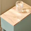 Close-up of a wooden tabletop with a glass of water. Náhľad obrázku produktu
