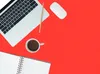 A top-down view of a laptop, mouse, coffee cup, pencil, and notebook on a red background. Podgląd zdjęcia produktu