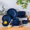 A set of blue stoneware dishes with a floral pattern, arranged on a table with lemons and a decorative plant. Náhled obrázku produktu