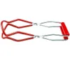A pair of red and silver jar lifter tongs against a white background. Produktbild-Vorschau