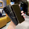 A person is holding a phone case with a phone inside, in what appears to be a cafe or restaurant setting. Náhled obrázku produktu