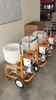 Several industrial machines are lined up in a warehouse or workshop setting. Anteprima dell’immagine prodotto