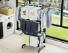 A laundry room with a washing machine and a multi-tiered drying rack filled with clothes. Náhľad obrázku produktu