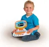 A young boy is sitting on the floor, holding and playing with a toy laptop. Produktbild-Vorschau