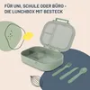A green lunchbox with its lid open, showing compartments, along with a fork, knife, and spoon. Decorative elements like a lemon and abstract shapes are present. Produktbild-Vorschau