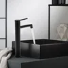 A black faucet is running water into a black square sink. Náhled obrázku produktu