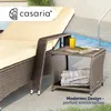 A polyrattan side table next to a lounge chair by a swimming pool. Produktbild-Vorschau