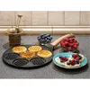 A waffle pan with waffles, blueberries, raspberries, and a mortar and pestle on a kitchen counter. Produktbild-Vorschau