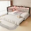 A bedroom scene featuring a modular sofa bed with a pull-out trundle bed, decorated with LED lighting and some accessories. Voir les images du produit