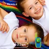Two children lying on a colorful blanket, one holding a walkie-talkie. Anteprima dell’immagine prodotto