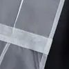 A close-up view of a white fabric curtain with stitched details and a white band across it. Produktbild-Vorschau