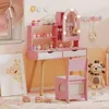 A child's pink vanity set with a mirror and accessories, placed in a room with a giraffe picture and stuffed lion. Podgląd zdjęcia produktu