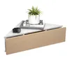 A white triangular corner shelf with a wooden drawer front, a potted plant, and two books. Voir les images du produit