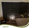 A bedroom with a large, textured black wall panel behind a bed. Podgląd zdjęcia produktu