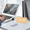 A person's hands are typing on a laptop, with a digital clock and a mouse on the desk. Produktbild-Vorschau