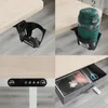 Collage showing details of a height-adjustable desk, including a cup holder, control panel, and a storage drawer with items. Voir les images du produit