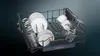 The interior of a dishwasher rack filled with clean dishes and glassware. Anteprima dell’immagine prodotto