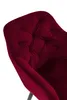 A close-up view of a red velvet armchair. Produktbild-Vorschau