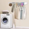 A laundry room scene with a washing machine, a drying rack with clothes, and a basket of towels. Produktbild-Vorschau