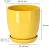 A yellow ceramic pot with a saucer, with dimensions indicated by measurement lines and text. Náhled obrázku produktu