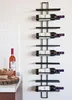 A wine rack mounted on a wall next to a kitchen counter with a bottle of wine and corks. Náhled obrázku produktu