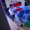 A person playing video games in a room decorated with Minecraft-themed items. Podgląd zdjęcia produktu
