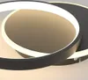 A close-up view of a modern LED ceiling light with two interlocking rings. Produktbild-Vorschau