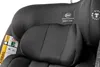 A close-up view of a car seat's headrest and safety labels. Náhled obrázku produktu