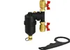 A magnetic sludge separator with brass fittings and red valve handles, along with a black wrench, is displayed against a white background. Podgląd zdjęcia produktu