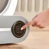 A hand is pressing a button on a control panel of a large automatic cat litter box. Anteprima dell’immagine prodotto