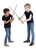 Two young boys are playing with toy lightsabers. Produktbild-Vorschau