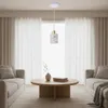 A modern living room with two sofas, a coffee table, and sheer curtains. Náhled obrázku produktu