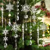 Christmas tree ornaments made of clear acrylic in the shape of snowflakes and icicles, hanging on a Christmas tree. Produktbild-Vorschau