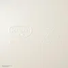 Embossed logos and text on a white surface. Produktbild-Vorschau