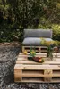 An outdoor seating area with pallet furniture, cushions, and fruit. Produktbild-Vorschau