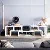 A modern living room with a white TV stand filled with electronics and decorative items. Náhled obrázku produktu