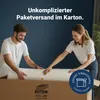 A couple is unboxing a rolled-up mattress from a large cardboard box. Produktbild-Vorschau