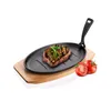A grilled steak on a cast iron pan, served on a wooden board with tomatoes. Voir les images du produit