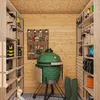 Interior of a shed or storage area with shelves, tools, and a large green grill. Náhľad obrázku produktu