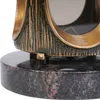 A close-up view of the base of a decorative item, likely a grave lantern, showing its textured metallic finish and granite base. Náhľad obrázku produktu