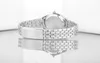 A close-up, side view of a silver watch with a metal band, resting on a reflective surface. Anteprima dell’immagine prodotto