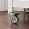 Close-up of a caster wheel on a white cabinet. Produktbild-Vorschau