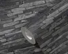 A close-up view of a roll of wallpaper with a stone pattern. Náhľad obrázku produktu