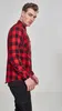 A man wearing a red and black checkered flannel shirt. Produktbild-Vorschau