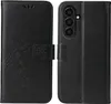 A black flip cover phone case with a floral and butterfly embossed design is shown. Produktbild-Vorschau