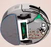 Underside view of a robot vacuum cleaner with a cutaway to show internal components like brushes and a dustbin. Voir les images du produit