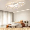 A bedroom with a bed, curtains, and a ceiling light. Podgląd zdjęcia produktu