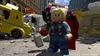 A LEGO minifigure of Thor stands in a destroyed city environment with damaged vehicles. Podgląd zdjęcia produktu