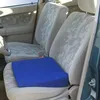 Interior of a car with a blue seat cushion on the driver's seat. Produktbild-Vorschau