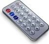 A silver remote control with various buttons is shown against a white background. Náhľad obrázku produktu
